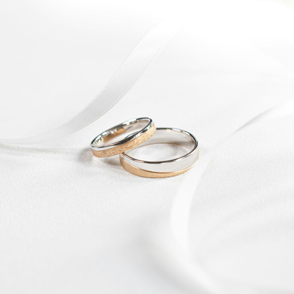 two wedding rings on white cloth